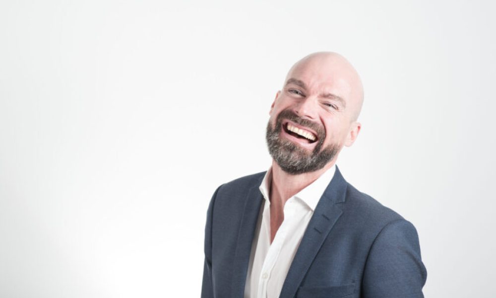 Adult Bald Man Laughing on White Background